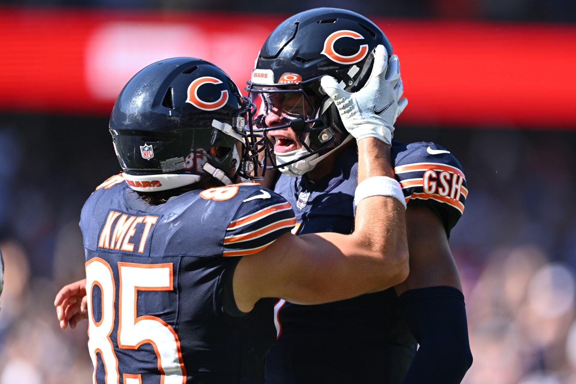 Justin Fields (1), right, celebrates with tight end Cole Kmet (85) after throwing his fourth touchdown pass of the day against the Denver Broncos in the third quarter at Soldier Field.