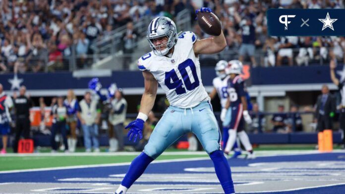 Dallas Cowboys RB Hunter Luepke (40) spikes the ball after a touchdown.