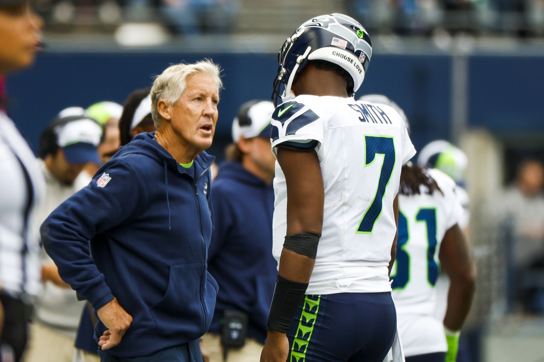 Pete Carroll talks with quarterback Geno Smith (7) following a three-and-out against the Carolina Panthers during the second quarter at Lumen Field.