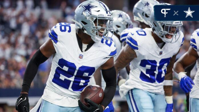 DaRon Bland (26) celebrates with teammates after returning an interception for a touchdown during the first half against the New England Patriots at AT&T Stadium.