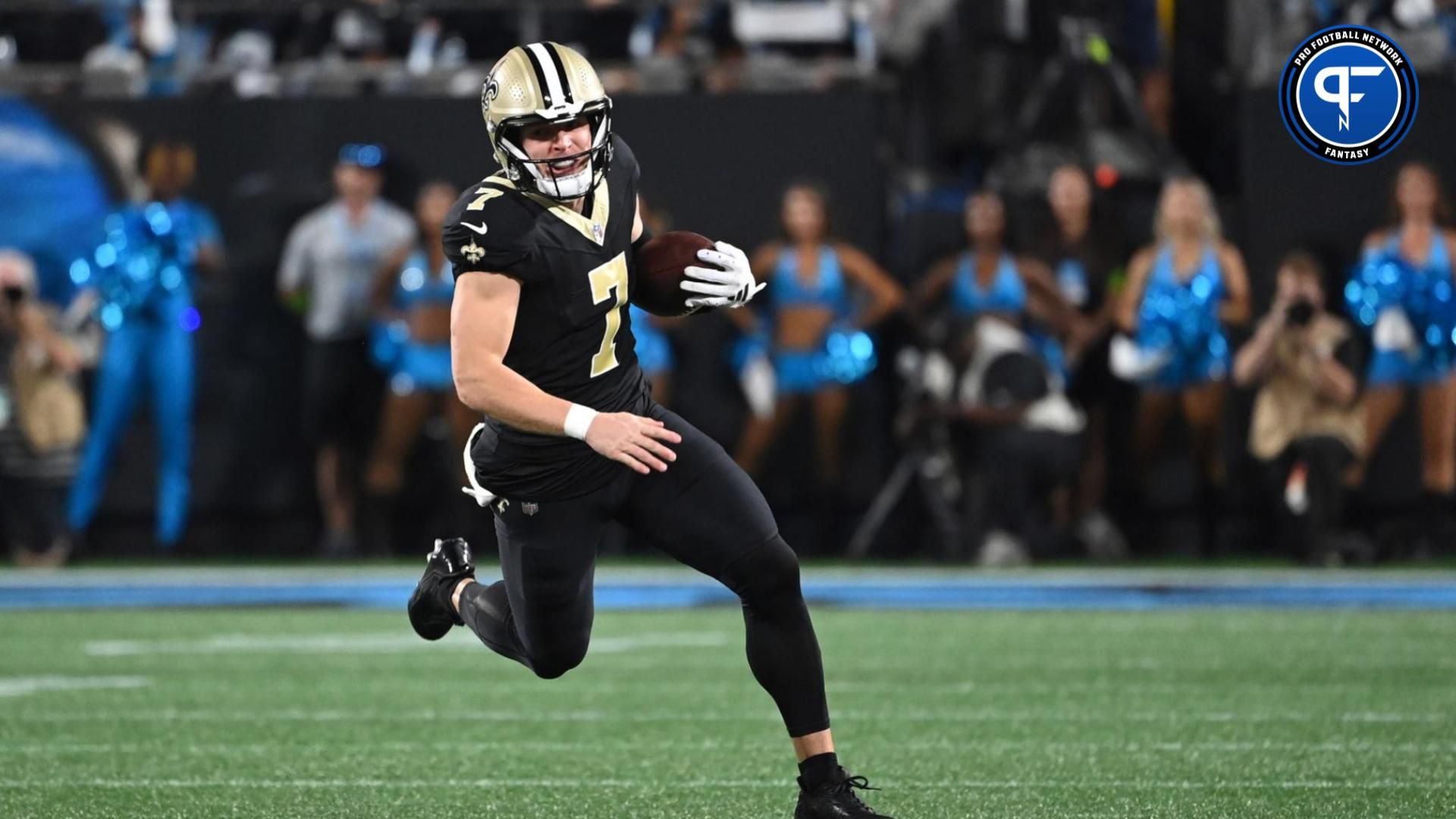 Taysom Hill (7) runs in the first quarter at Bank of America Stadium.