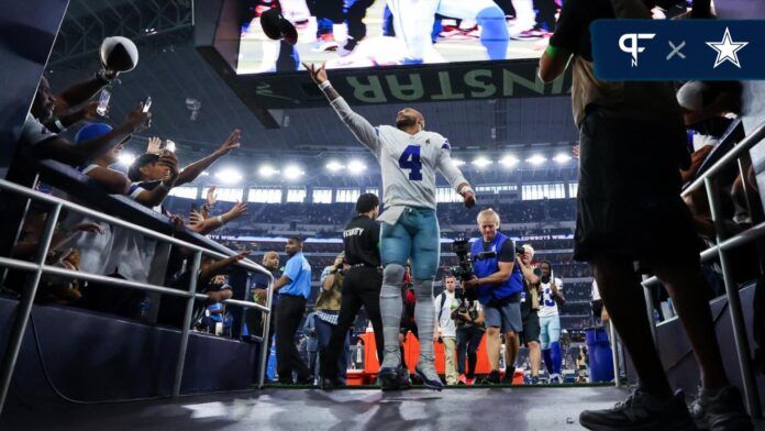 Dak Prescott (4) celebrates with fans after the game against the New England Patriots at AT&T Stadium.