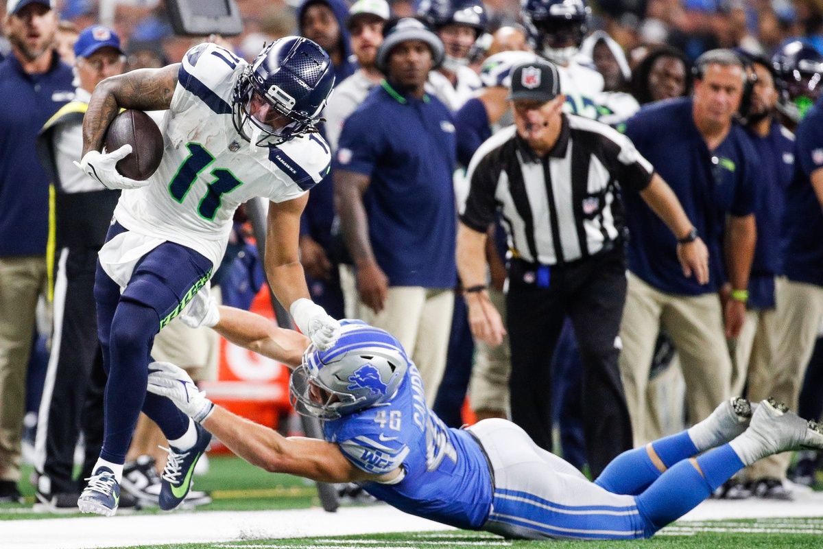 Seattle Seahawks WR Jaxon Smith-Njigba (11) is tackled out of bounds.