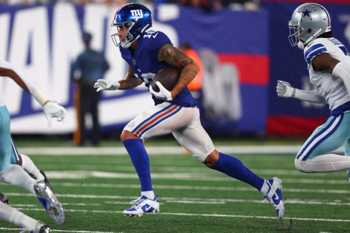 Isaiah Hodgins (18) runs with the ball against the Dallas Cowboys during the second half at MetLife Stadium.