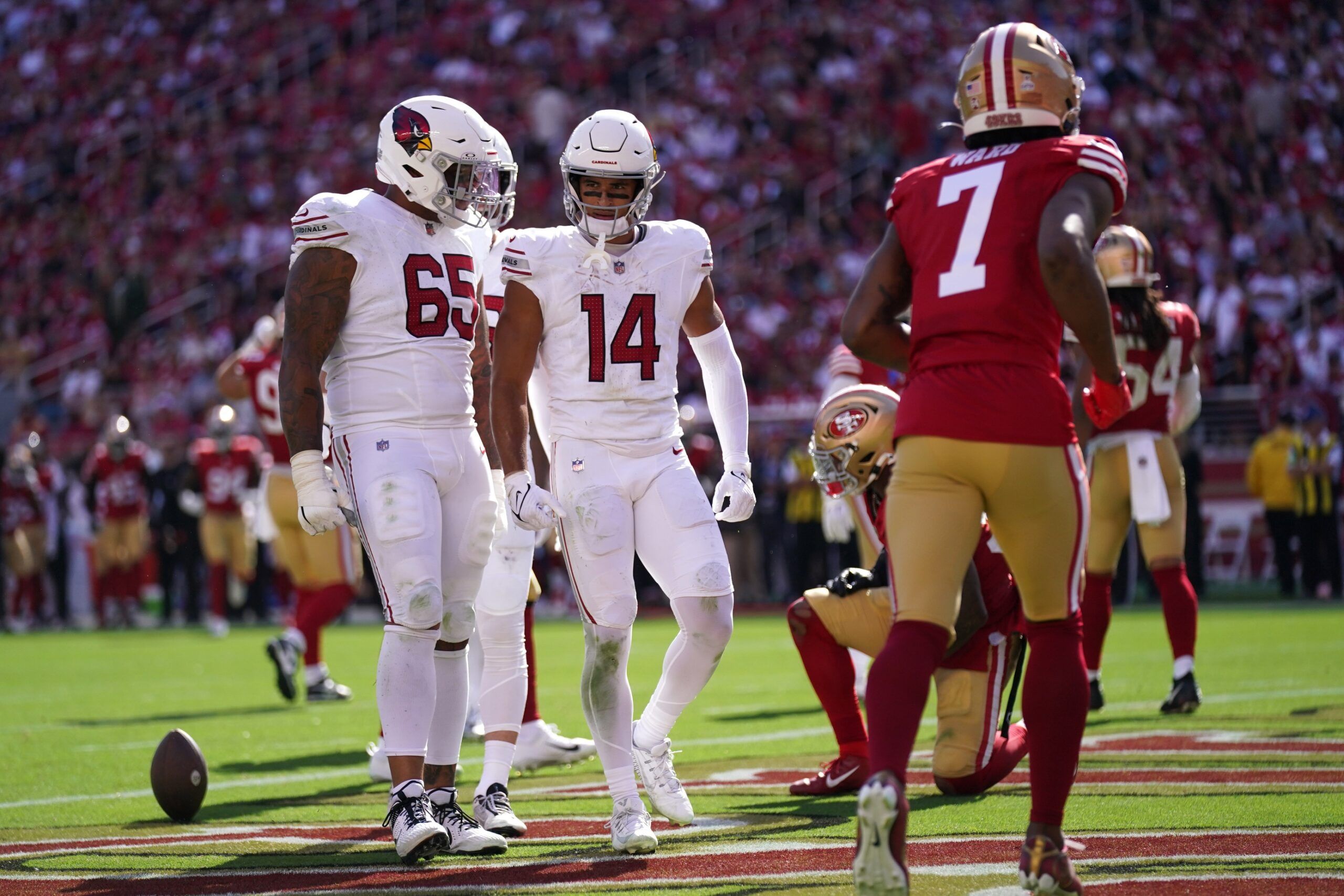 Michael Wilson (14) reacts next to offensive tackle Elijah Wilkinson (65) after catching a touchdown pass against the San Francisco 49ers in the third quarter at Levi's Stadium.