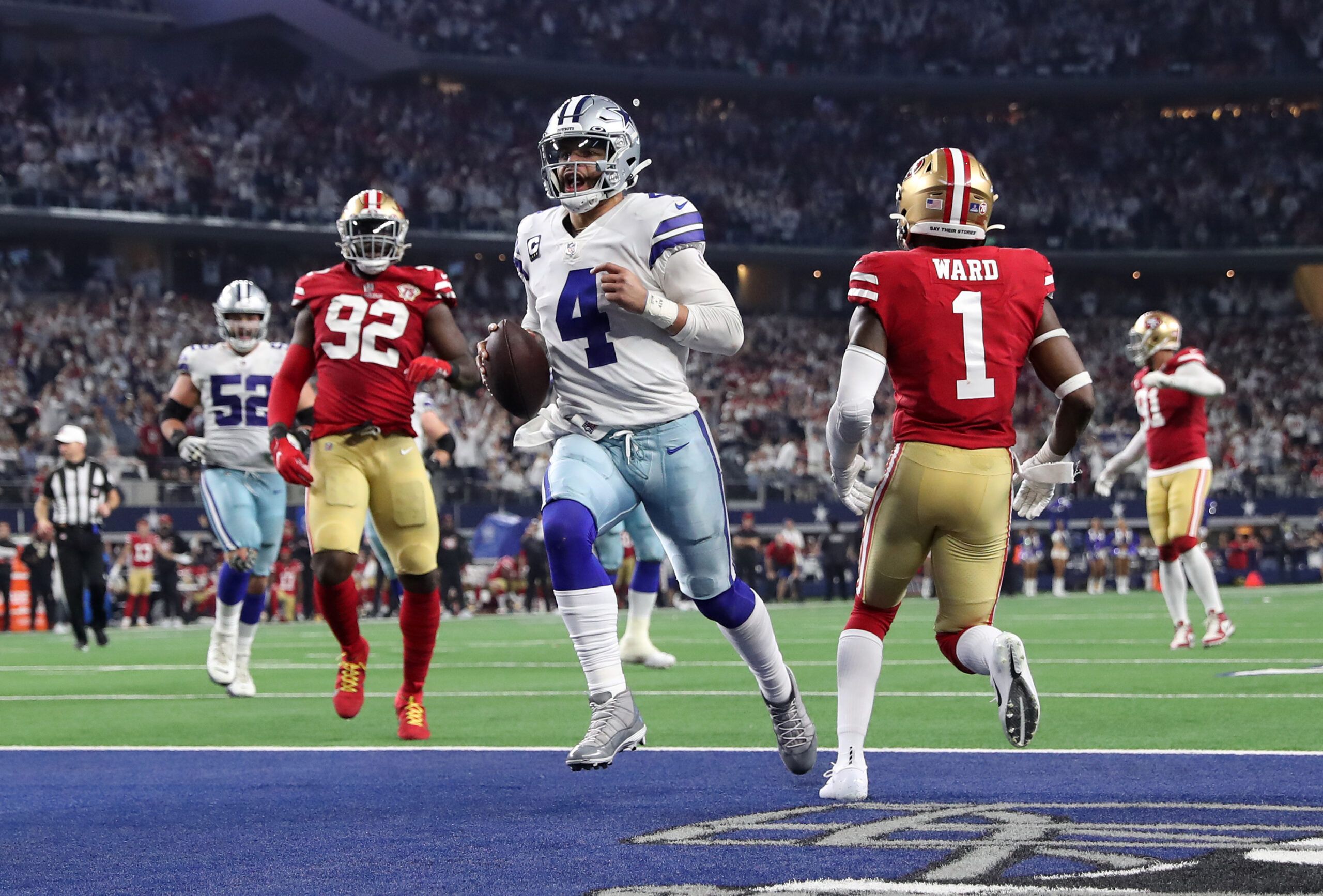 Jan 16, 2022; Arlington, Texas, USA; Dallas Cowboys quarterback Dak Prescott (4) runs for a touchdown against the San Francisco 49ers during the second half of the NFC Wild Card playoff football game at AT&T Stadium.