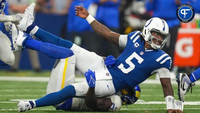 Indianapolis Colts quarterback Anthony Richardson taken to the ground by a Los Angeles Rams defender.