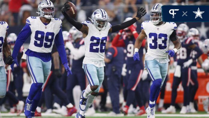 Dallas Cowboys players celebrate CB Daron Bland's (26) interception.