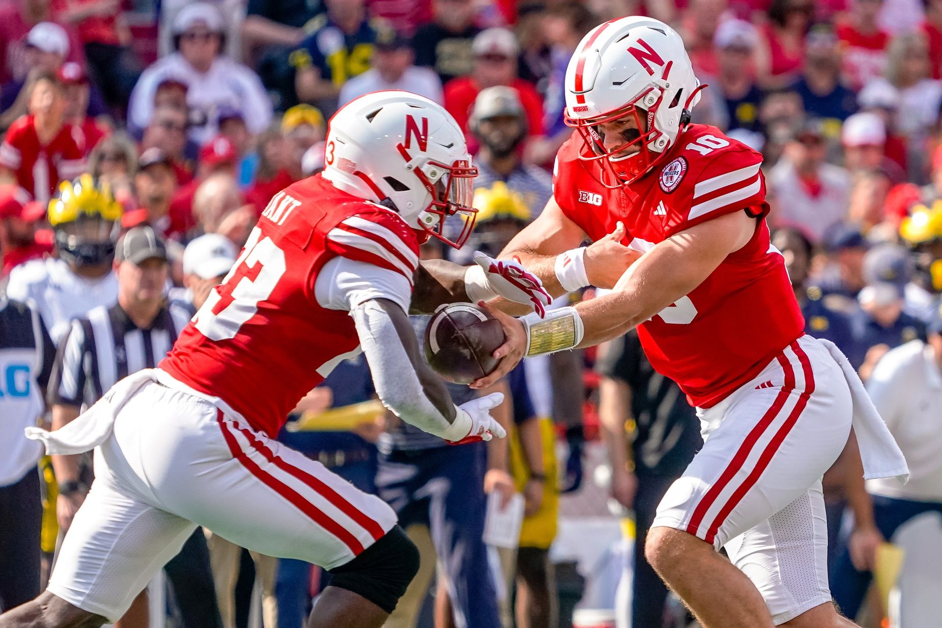 Nebraska Cornhuskers quarterback Heinrich Haarberg (10) hands the ball off to running back Anthony Grant (23).