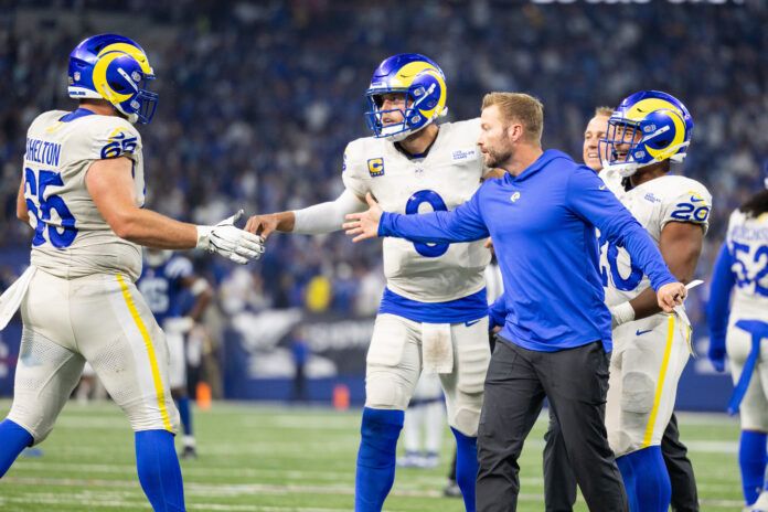 Los Angeles Rams quarterback Matthew Stafford (9) celebrates his game winning pass with teammates and head coach Sean McVay in the overtime against the Indianapolis Colts at Lucas Oil Stadium.