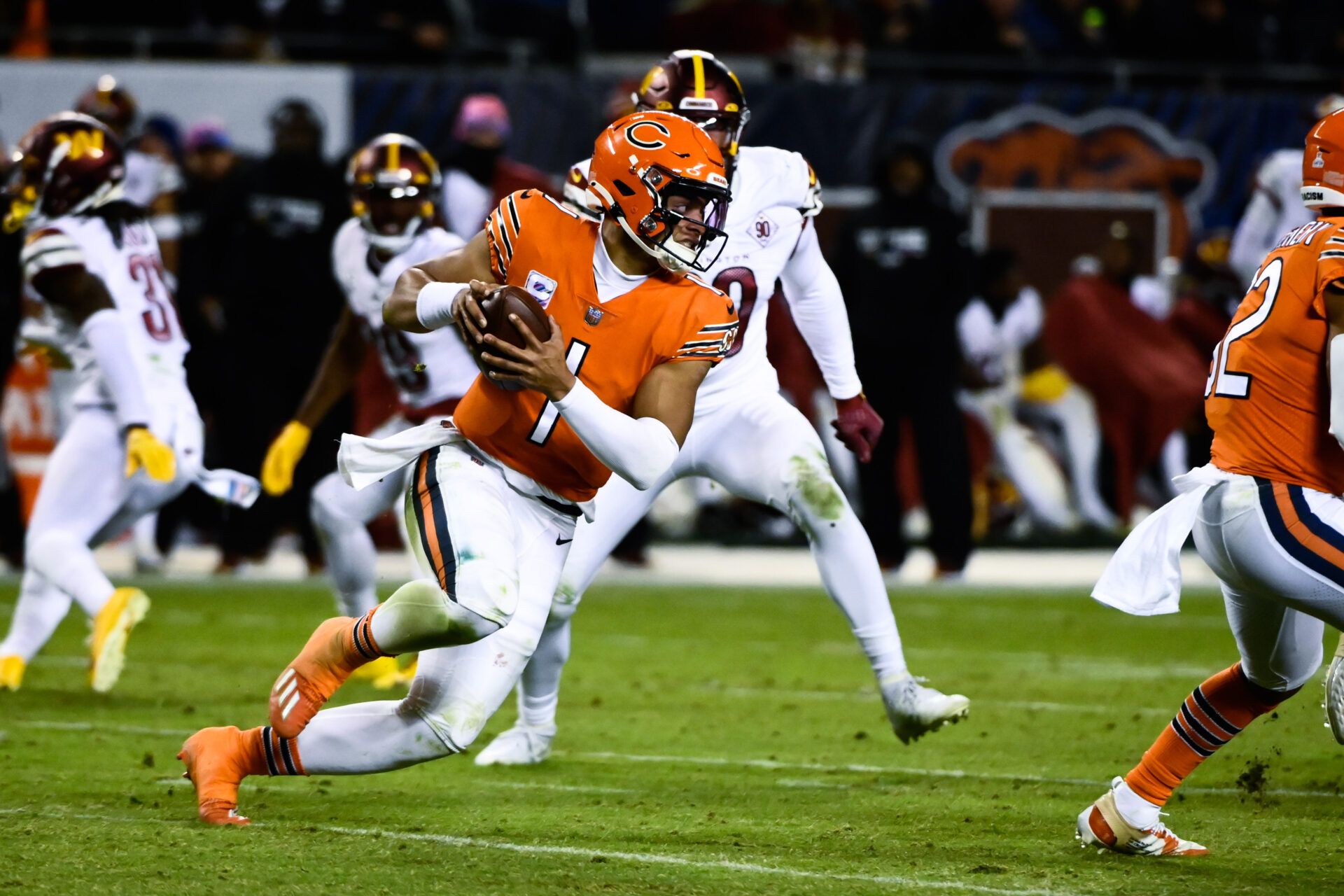 Chicago Bears quarterback Justin Fields (1) runs with the ball against the Washington Commanders during the second half at Soldier Field.