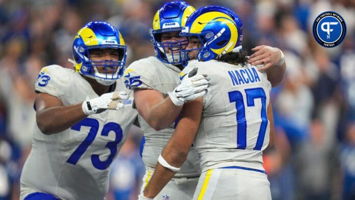 The Los Angeles Rams celebrate the game-winning touchdown by wide receiver Puka Nacua (17) during overtime on Sunday, Oct. 1, 2023, at Lucas Oil Stadium in Indianapolis.