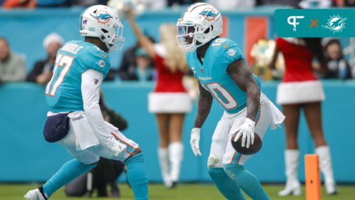 Miami Dolphins wide receivers Jaylen Waddle (17) and Tyreek Hill (10) celebrate a touchdown.