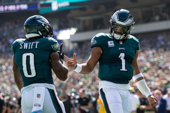 Philadelphia Eagles QB Jalen Hurts (1) and D'Andre Swift (0) celebrate a touchdown.