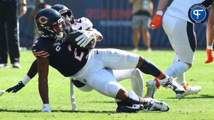 Chicago Bears wide receiver tackled after a catch by a Denver Broncos defender.