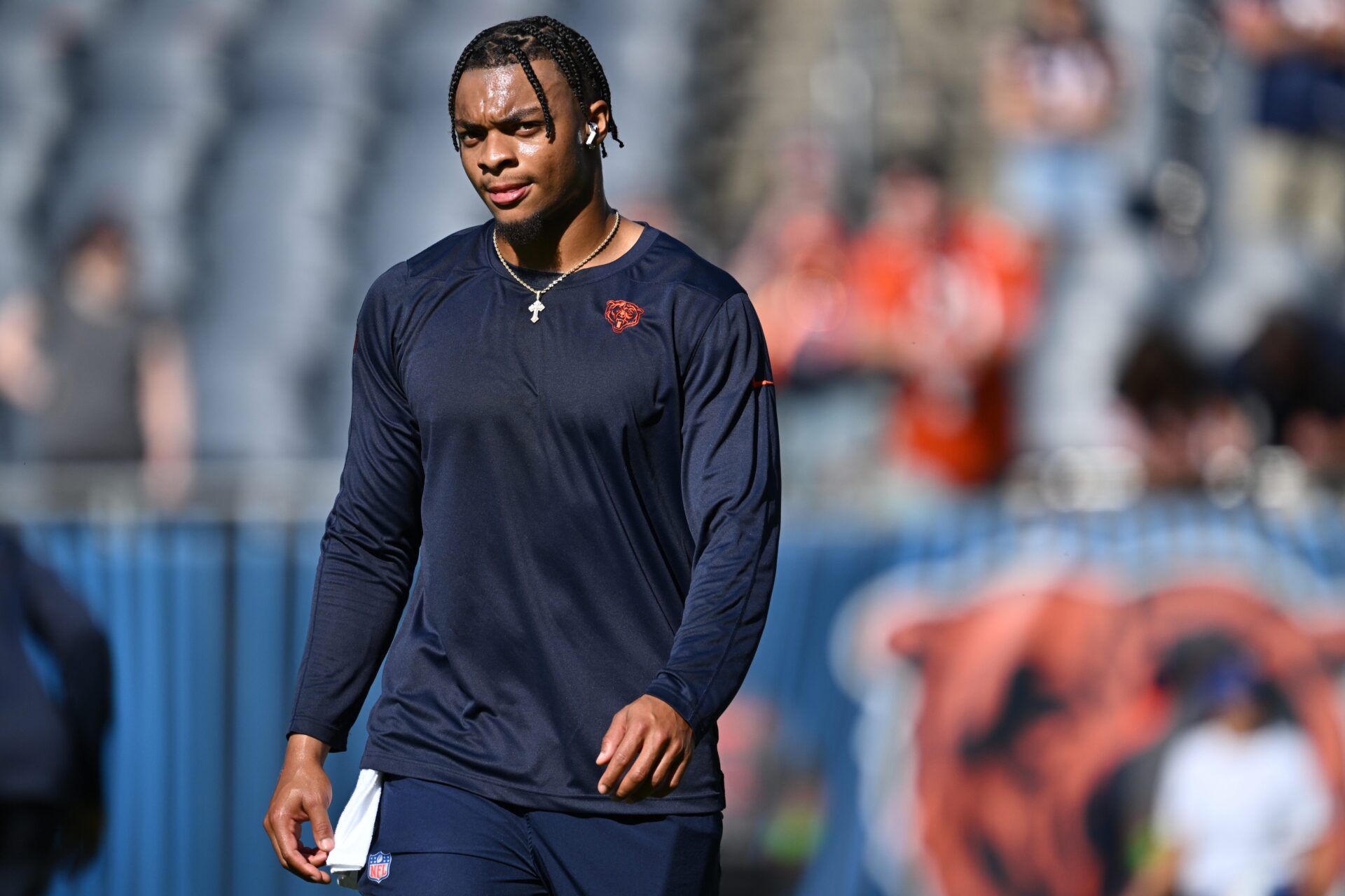 Chicago Bears QB Justin Fields walks on the field before a game.