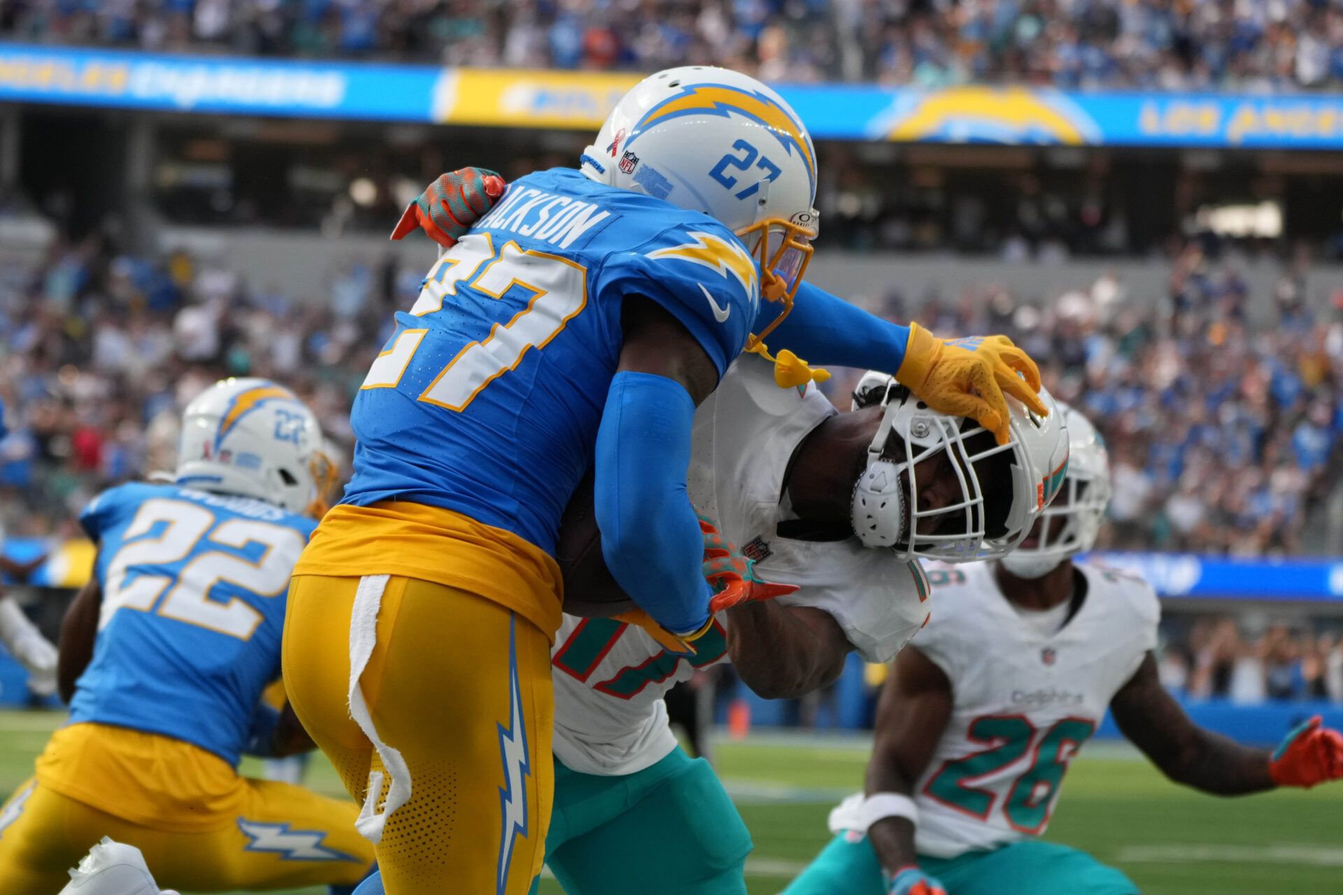 Sep 10, 2023; Inglewood, California, USA; Los Angeles Chargers cornerback J.C. Jackson (27) carries the ball on an interception return against Miami Dolphins wide receiver Jaylen Waddle (17) in the second half at SoFi Stadium. Mandatory Credit: Kirby Lee-USA TODAY Sports