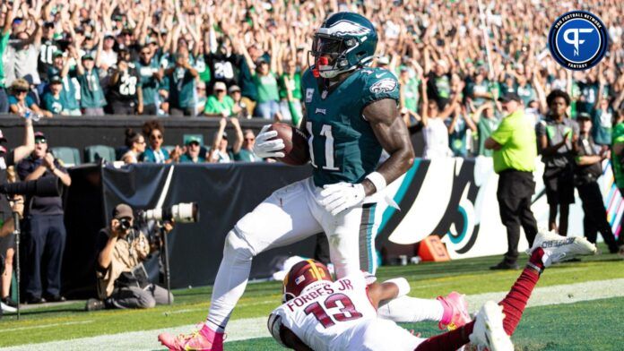 A.J. Brown (11) catches a touchdown pass past Washington Commanders cornerback Emmanuel Forbes (13) during the fourth quarter at Lincoln Financial Field.