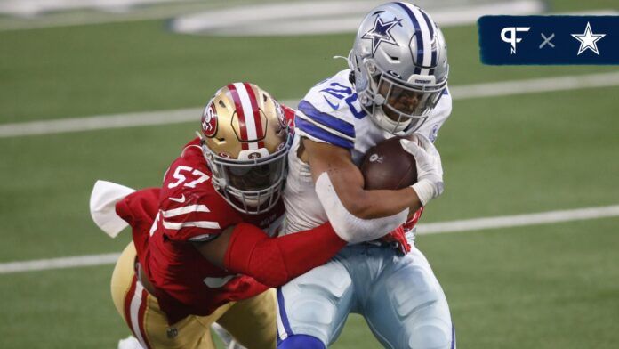 Dallas Cowboys running back Tony Pollard (20) is tackled by San Francisco 49ers outside linebacker Dre Greenlaw (57) in the second quarter at AT&T Stadium.