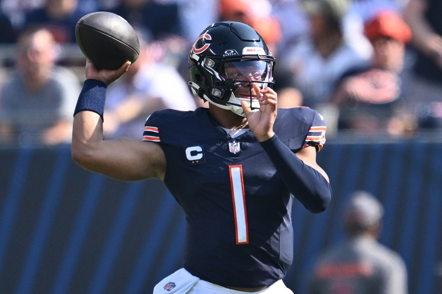 Justin Fields (1) passes in the first half against the Green Bay Packers at Soldier Field.