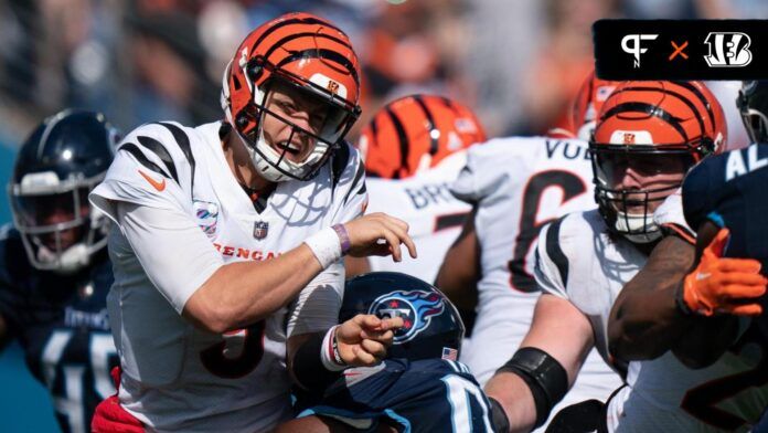 Joe Burrow (9) takes a hit by Tennessee Titans defensive tackle Teair Tart (93) in the fourth quarter at Nissan Stadium.