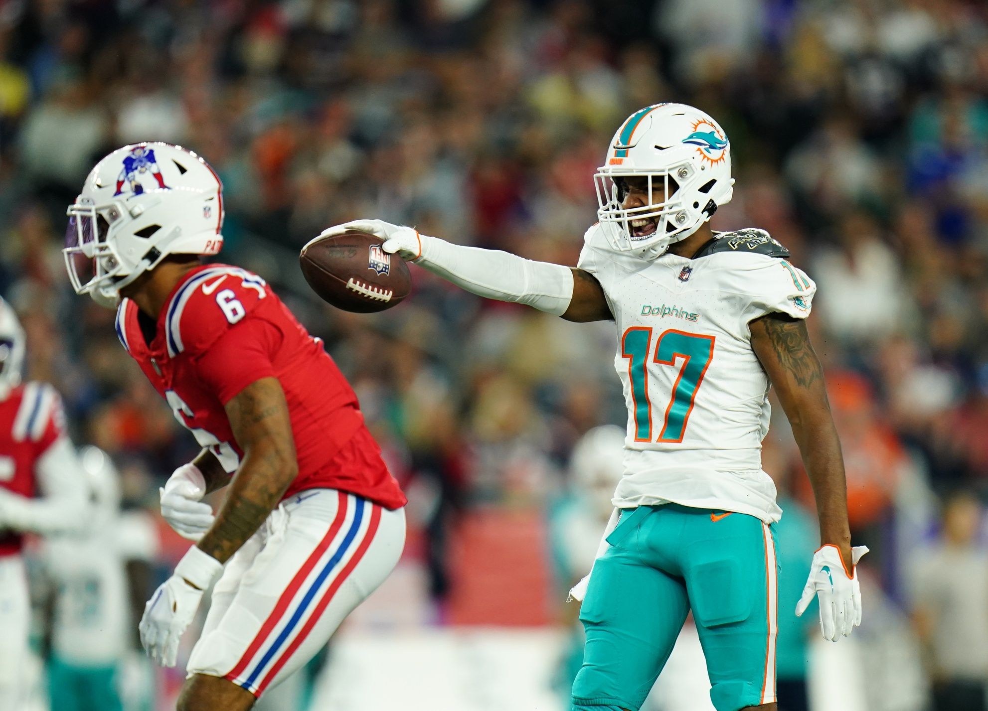 Jaylen Waddle (17) reacts after his first down catch against New England Patriots cornerback Christian Gonzalez (6) in the second quarter at Gillette Stadium.