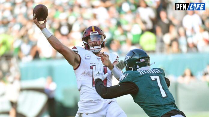 Sam Howell throws a pass before getting hit against the Philadelphia Eagles.