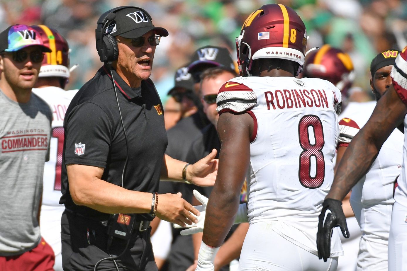 Washington Commanders head coach Ron Rivera talks to RB Brian Robinson (8) on the sidelines.