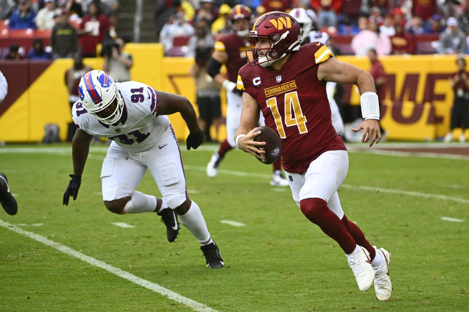 Washington Commanders QB Sam Howell (14) runs with the ball against the Buffalo Bills.