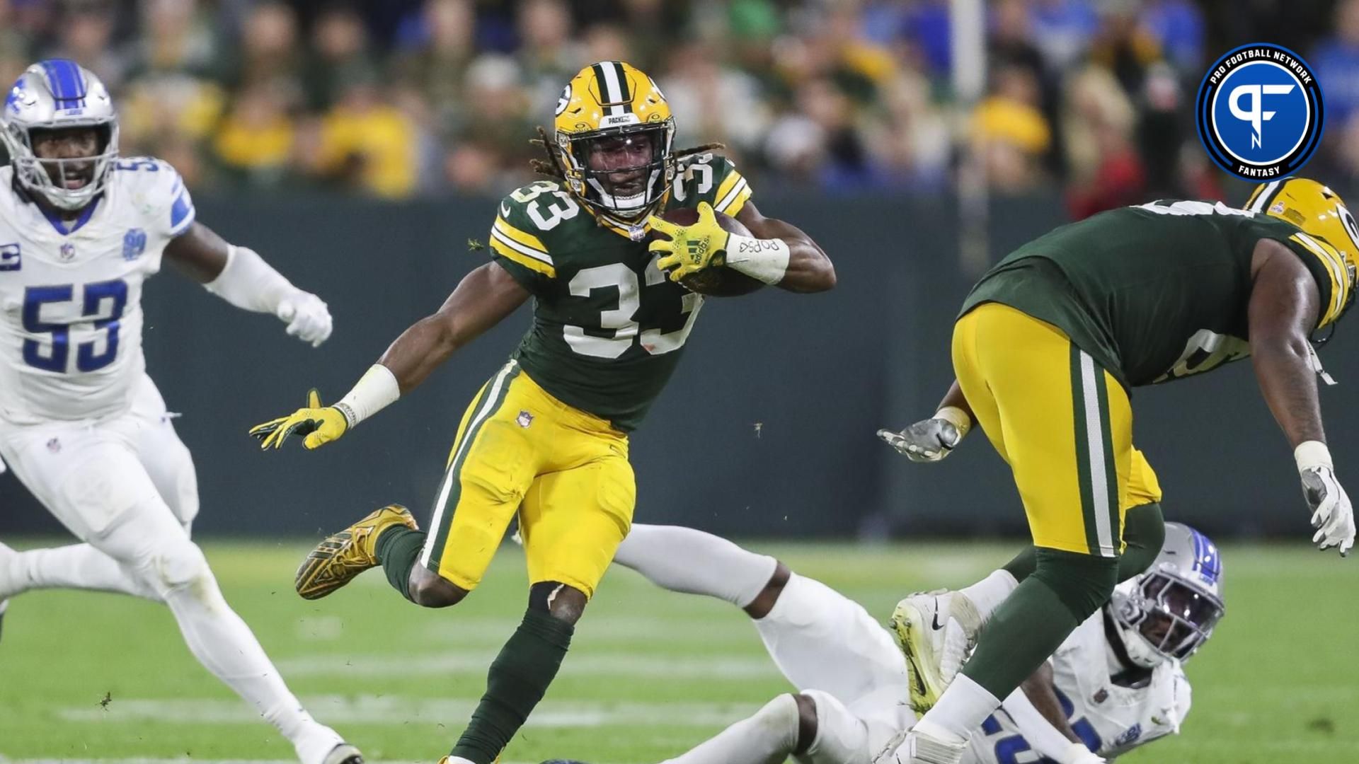 Green Bay Packers RB Aaron Jones avoids tackle of Detroit Lions defender.