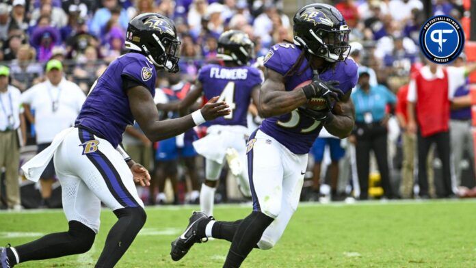 Baltimore Ravens RB Gus Edwards runs with ball after taking handing in game vs. the Houston Texans.