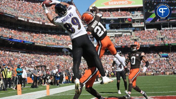 Baltimore Ravens tight end Mark Andrews (89) catches a touchdown as Cleveland Browns cornerback Denzel Ward (21) and safety Juan Thornhill (1) and cornerback Greg Newsome II (0) defend and during the first half at Cleveland Browns Stadium.