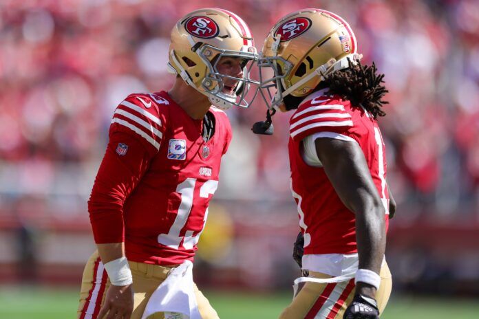 Brock Purdy (13) celebrates after a touchdown during the second quarter against the Arizona Cardinals at Levi's Stadium.