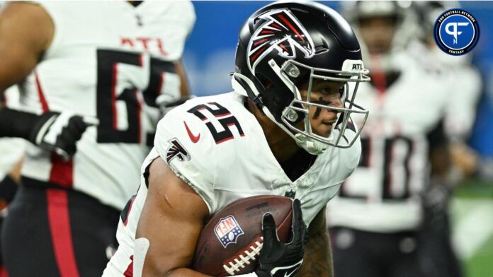 Tyler Allgeier (25) runs the ball during pre-game warmups before their game against the Detroit Lions at Ford Field.