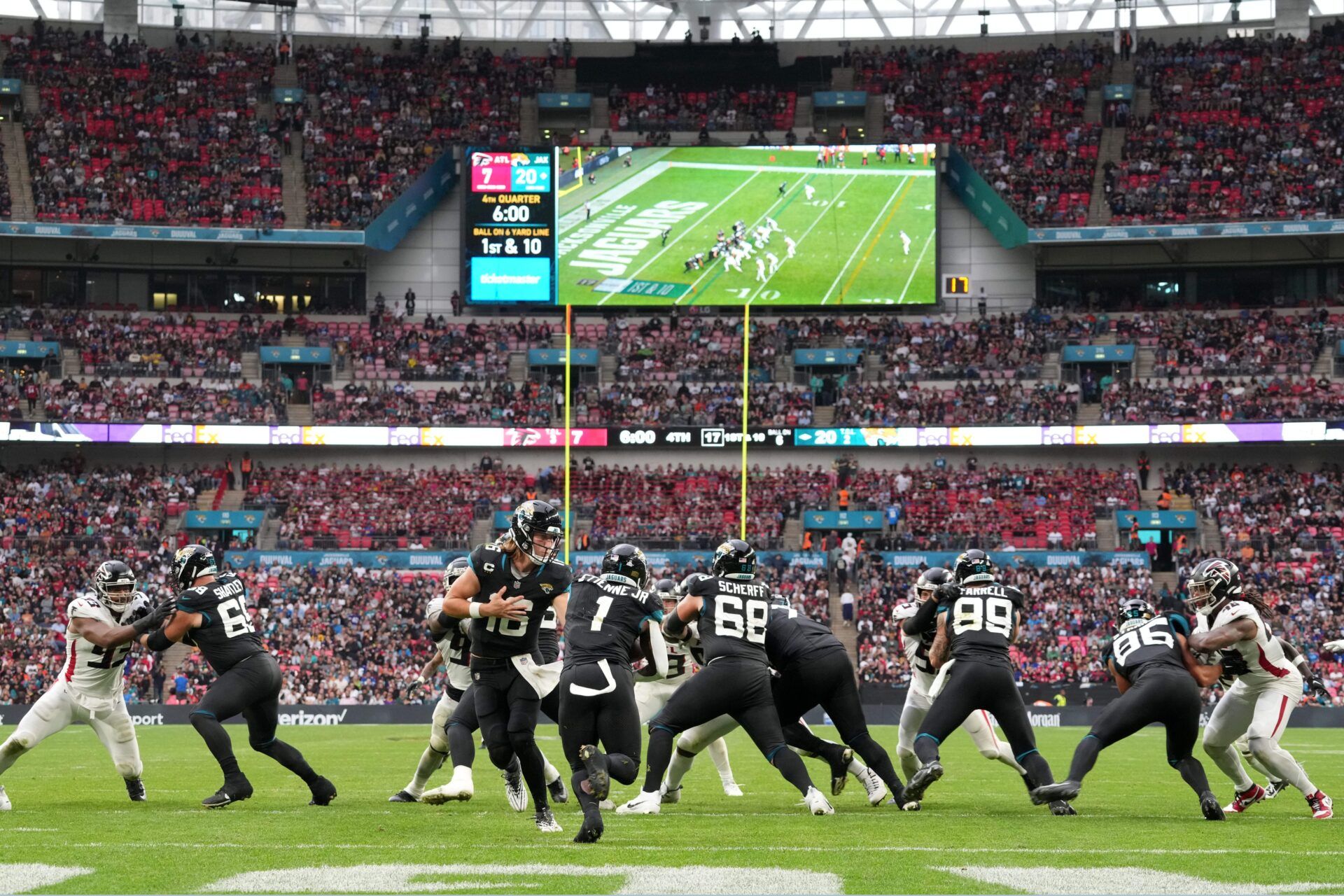 A general overall view as Jacksonville Jaguars quarterback Trevor Lawrence (16) hands the ball off to running back Travis Etienne Jr. (1) in the second half against the Atlanta Falcons during an NFL International Series game at Wembley Stadium.