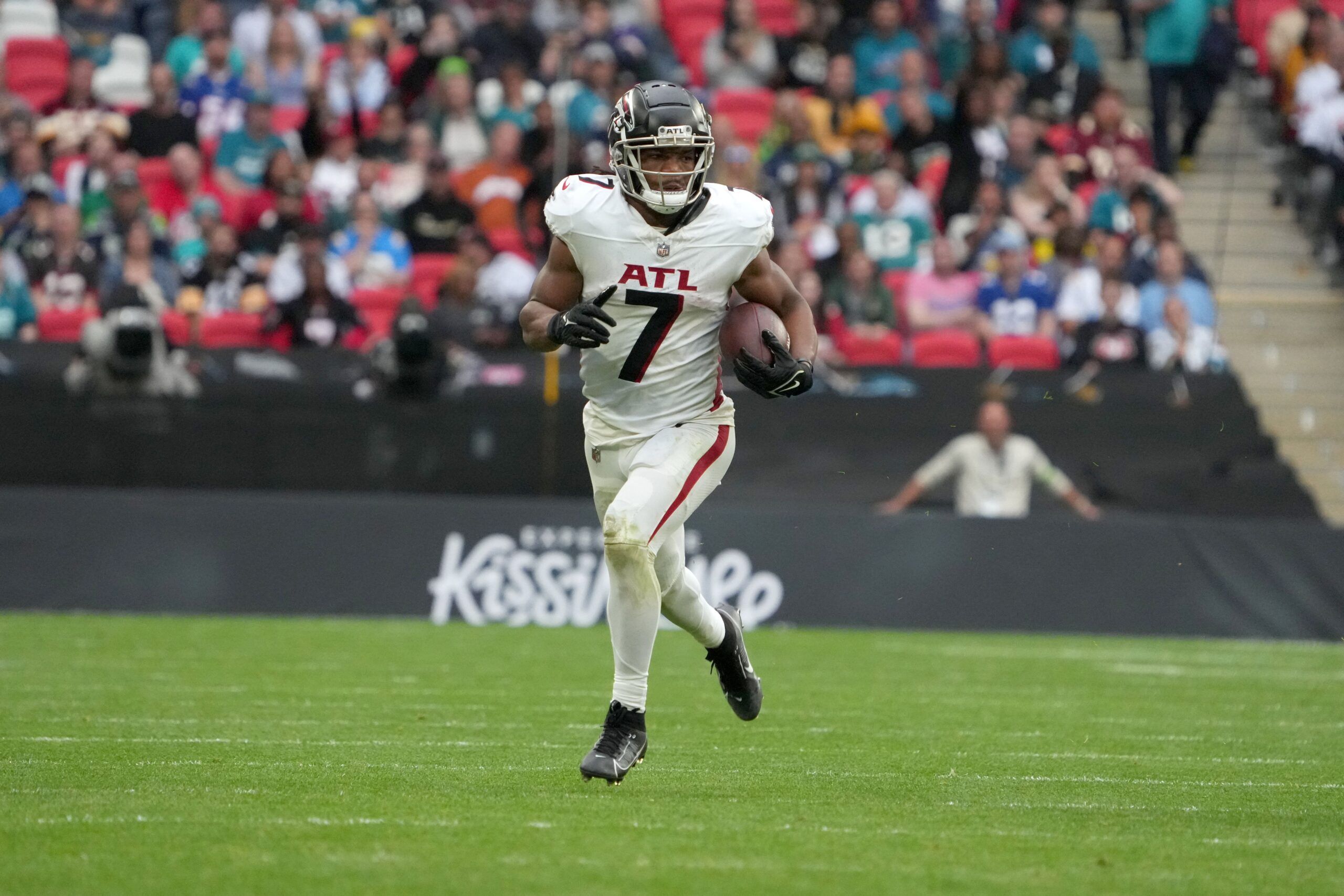 Bijan Robinson (7) carries the ball against the Jacksonville Jaguars in the second half during an NFL International Series game at Wembley Stadium.