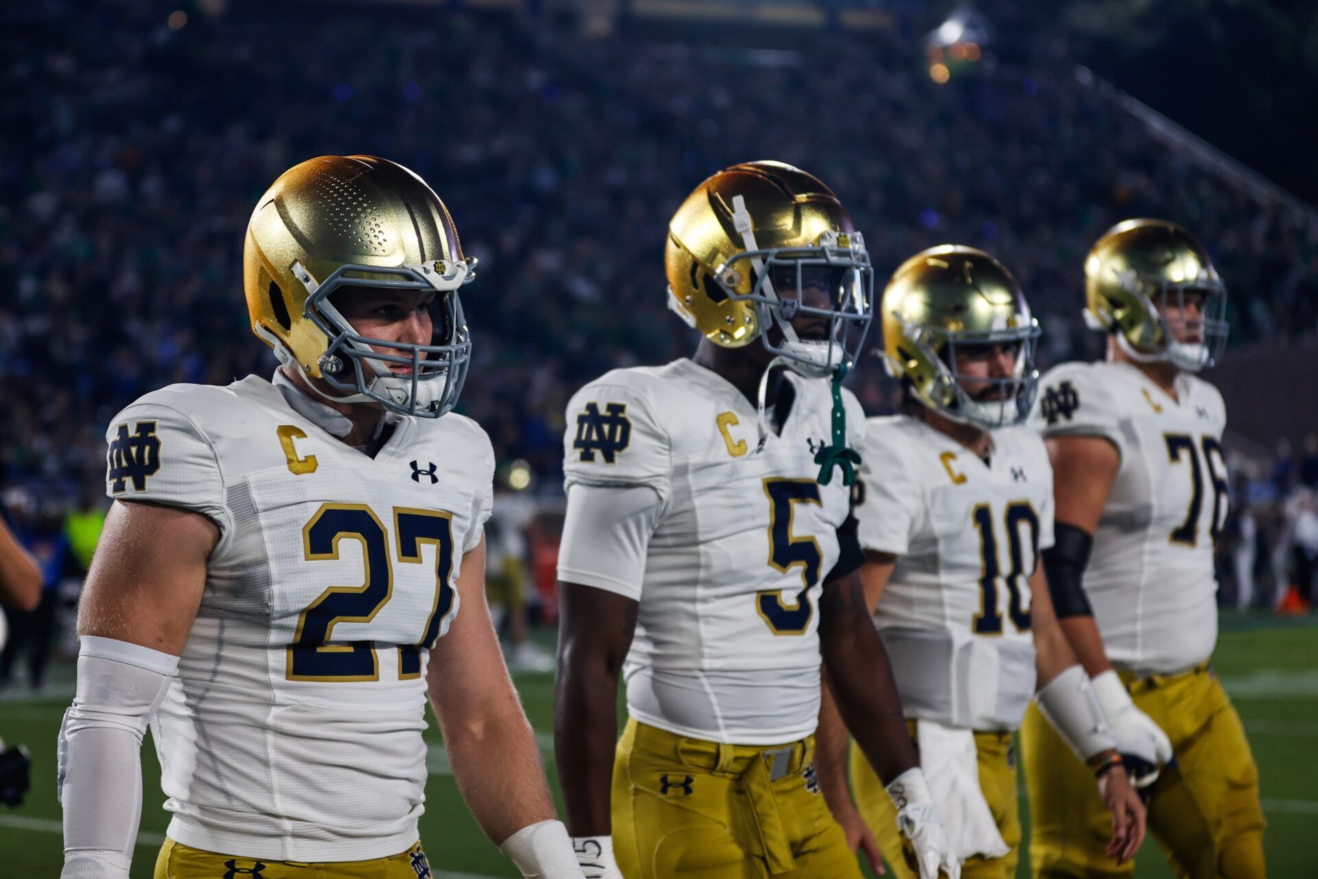 Chase Ketterer (27), wide receiver Tobias Merriweather (5),quarterback Sam Hartman (10), and offensive lineman Joe Alt (76) walk out before the first half of the game against Duke Blue Devils at Wallace Wade Stadium.