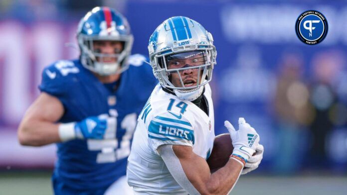 Detroit Lions wide receiver Amon-Ra St. Brown (14) gains yards after the catch during the first half as New York Giants linebacker Micah McFadden (41) pursues at MetLife Stadium.