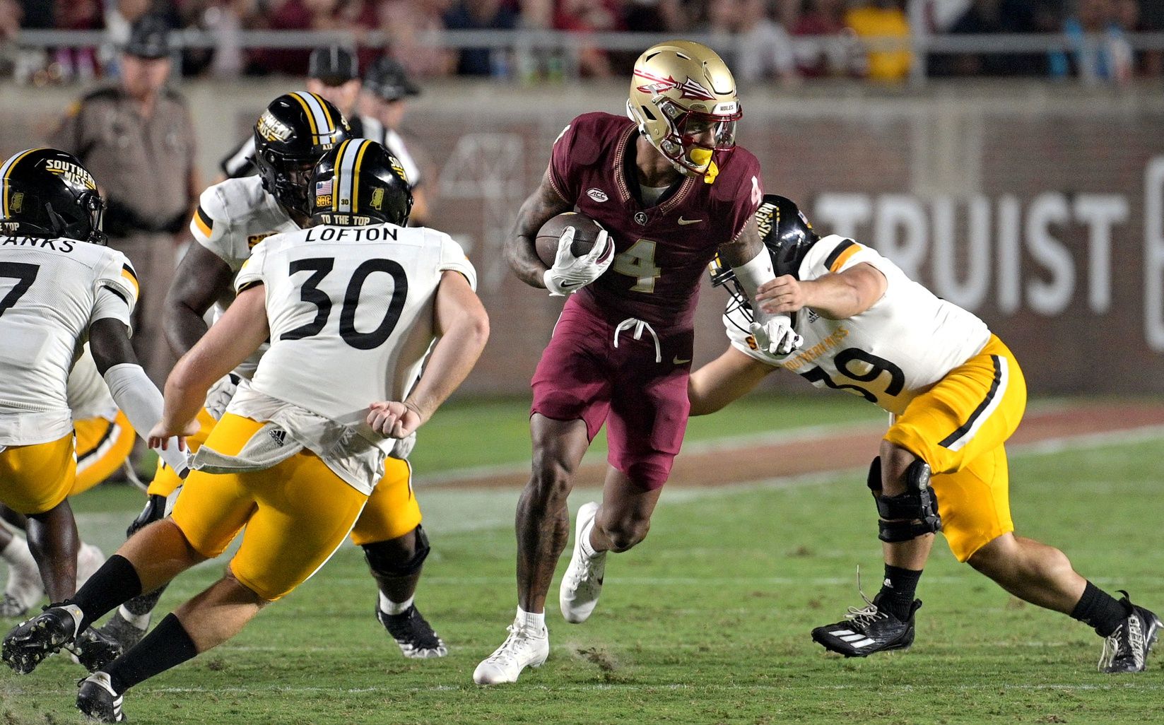 Keon Coleman (4) runs the ball during the first half against Southern Miss Golden Eagles at Doak S. Campbell Stadium.