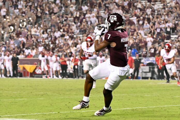 Moose Muhammad III (7) catches a pass during the fourth quarter against the New Mexico Lobos at Kyle Field.