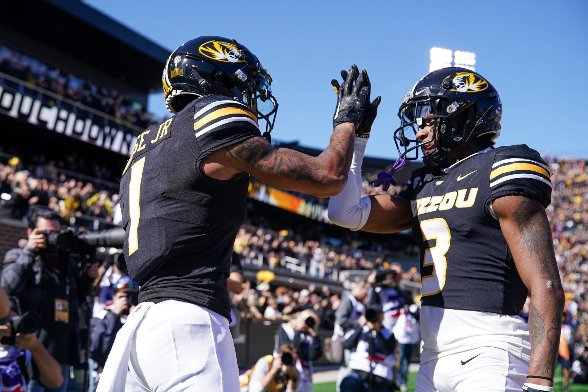 Luther Burden III (3) celebrates with wide receiver Theo Wease Jr. (1) after Wease’s touchdown against the LSU Tigers during the first half at Faurot Field at Memorial Stadium.