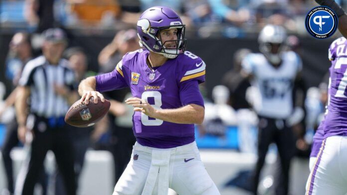 Kirk Cousins (8) moves back to throw against the Carolina Panthers during the first quarter at Bank of America Stadium.