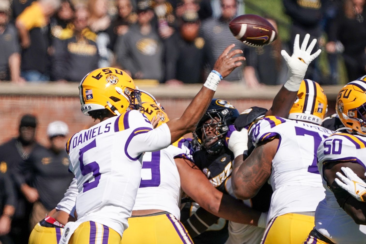 Jayden Daniels (5) throws a pass against the Missouri Tigers during the first half at Faurot Field at Memorial Stadium.