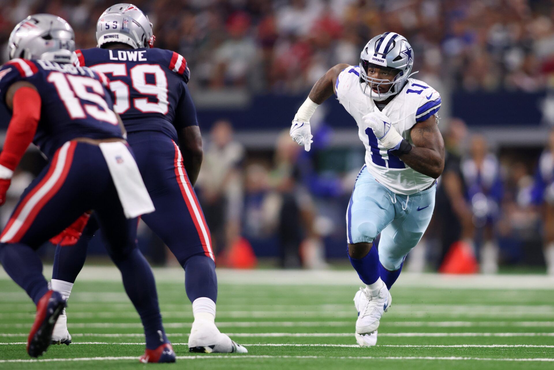 Micah Parsons (11) rushes as New England Patriots offensive tackle Vederian Lowe (59) in the third quarter at AT&T Stadium.