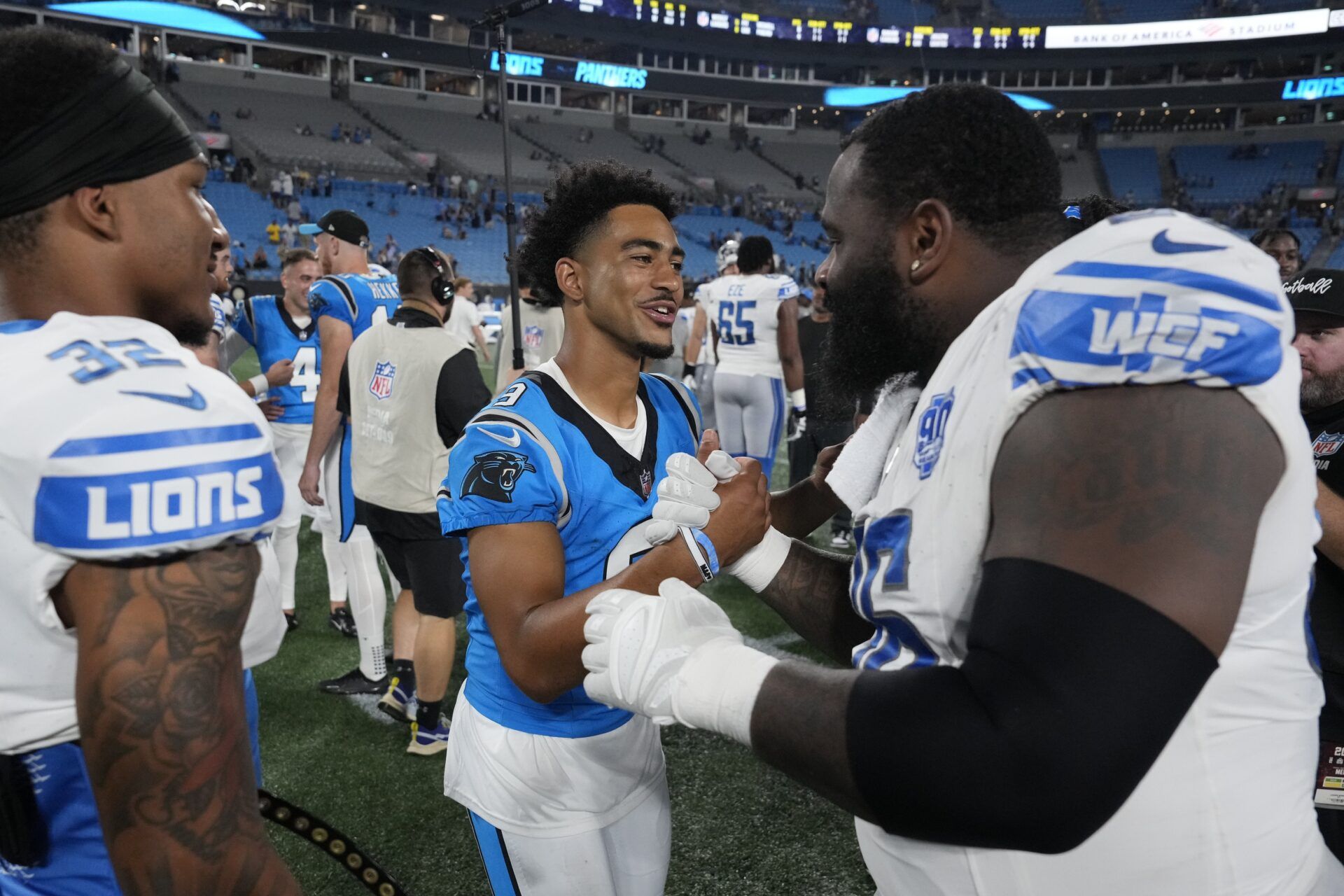 Carolina Panthers quarterback Bryce Young (9) with Detroit Lions safety Brian Branch (32) and defensive end Isaiah Buggs (96) after the game at Bank of America Stadium.