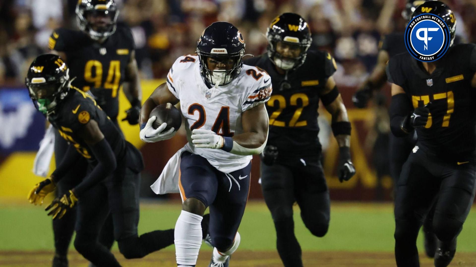 Chicago Bears running back Khalil Herbert (24) carries the ball as Washington Commanders linebacker Cody Barton (57) chases during the first quarter at FedExField.