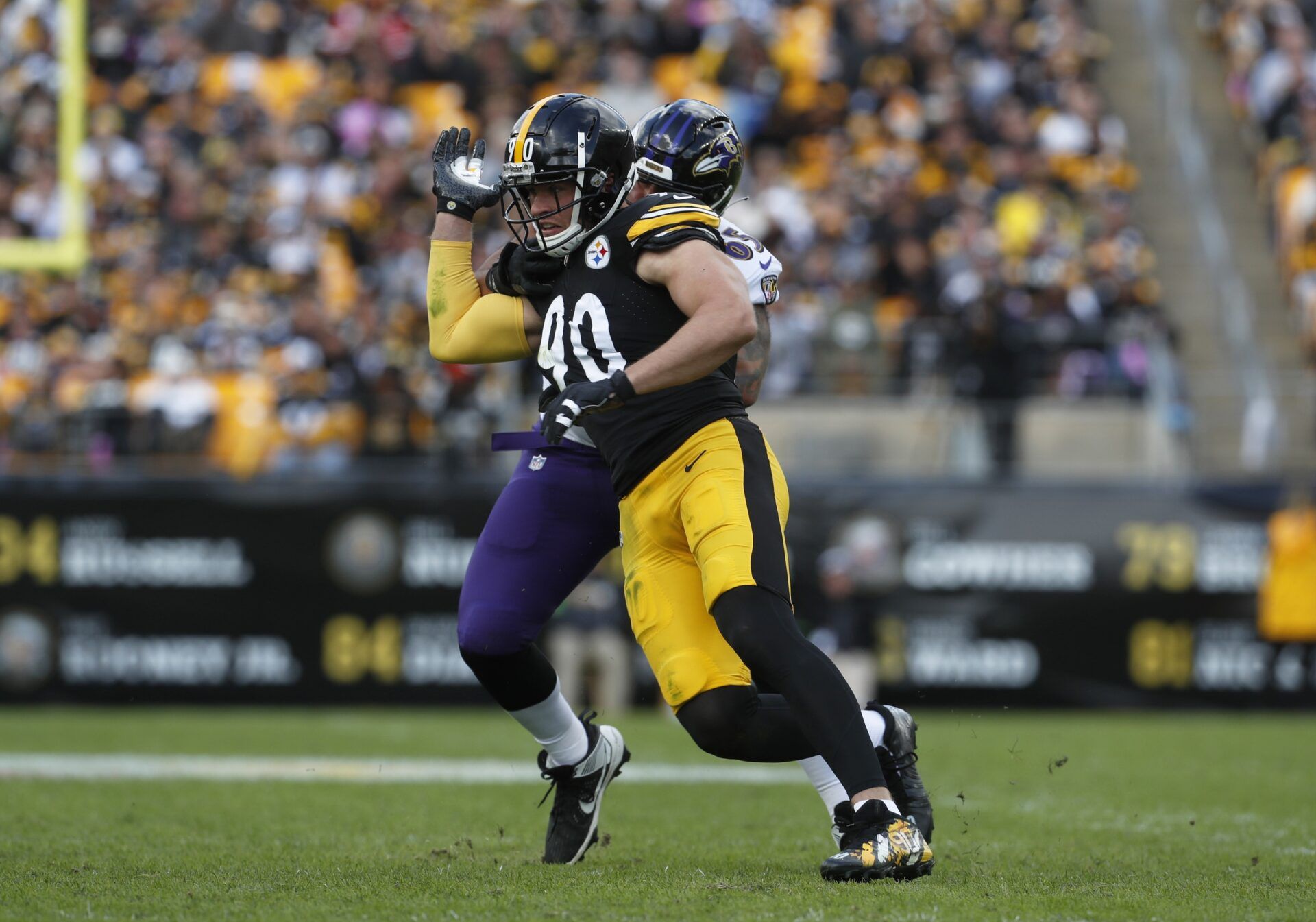 T.J. Watt (90) pass rushes at the line of scrimmage past Baltimore Ravens guard Patrick Mekari (rear) during the second quarter at Acrisure Stadium.