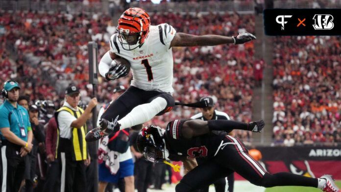 Ja'Marr Chase (1) leaps over Arizona Cardinals cornerback Kei'Trel Clark (13) at State Farm Stadium.