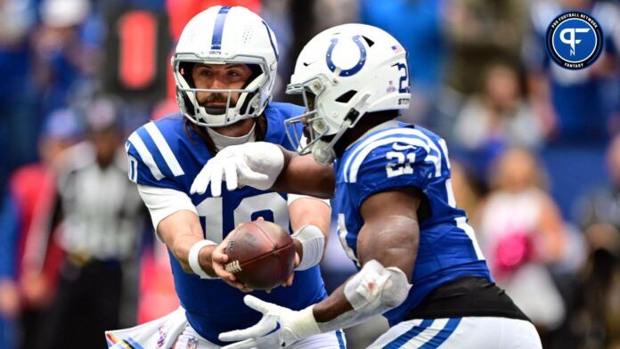 Gardner Minshew (10) hands the ball off to Indianapolis Colts running back Zack Moss (21) during the second half against the Tennessee Titans at Lucas Oil Stadium.