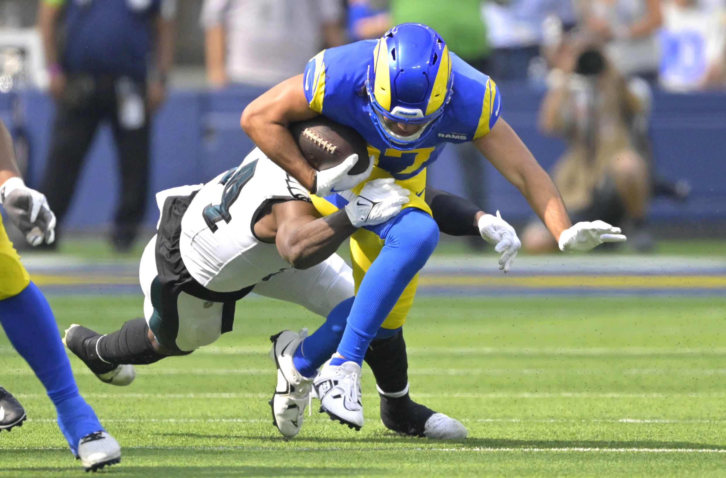 Philadelphia Eagles CB James Bradberry (24) tackles Los Angeles Rams WR Puka Nacua (17).